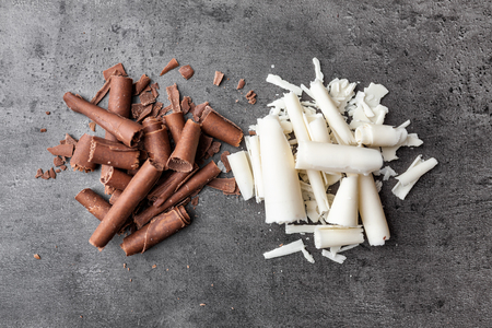 Delicious milk and white chocolate swilrs on rustic backgroundの写真素材