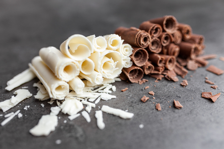 Delicious milk and white chocolate swilrs on rustic backgroundの写真素材