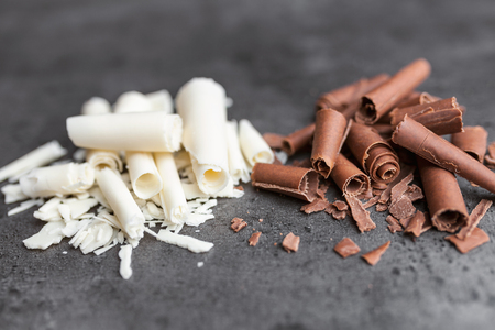 Delicious milk and white chocolate swilrs on rustic backgroundの写真素材