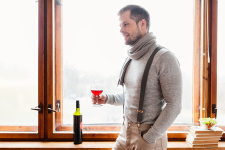 Hansome man enjoying a glass of good red wineの写真素材