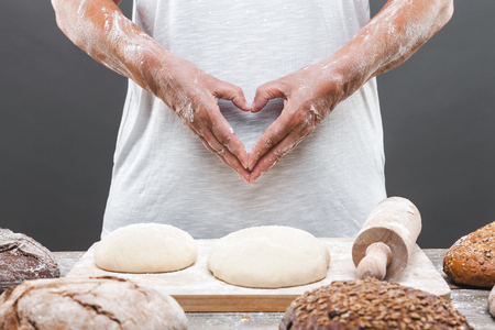 Baker preparing a variety delicious fresh bread and pastryの写真素材