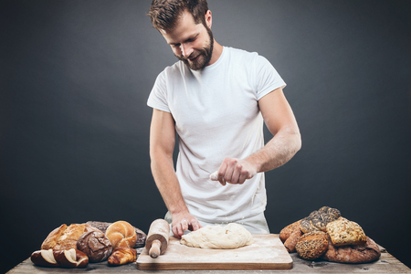 Baker with a variety of healthy and delicious freshly baked bread and pastryの写真素材