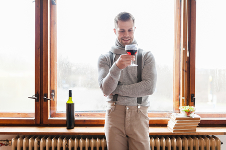 Hansome man enjoying a glass of good red wineの写真素材