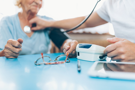 Senior woman during a medical exam with her practitionerの写真素材