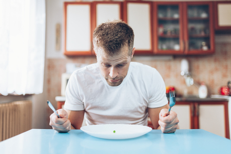 Young man at home on a healthy dietの写真素材