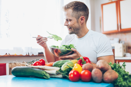 Young man at home on a healthy dietの写真素材