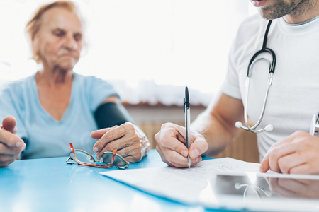 Senior woman during a medical exam with her practitionerの写真素材