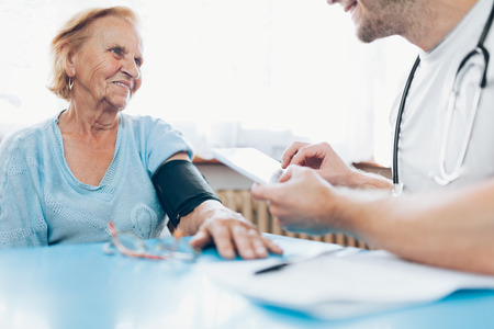 Senior woman during a medical exam with her practitionerの写真素材