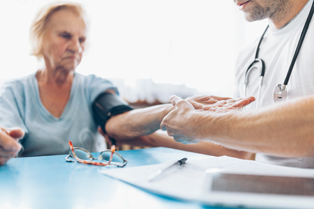 Senior woman during a medical exam with her practitionerの写真素材