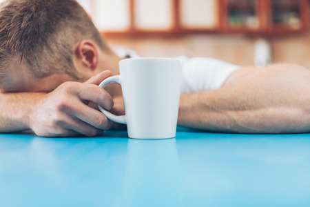 Man trying to wake up in the morning after night outの写真素材