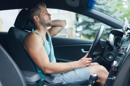 Man with lots of back pain after a long drive in carの写真素材