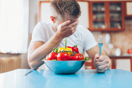 Young man at home on a healthy dietの写真素材