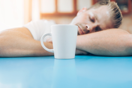 Man trying to wake up in the morning after night outの写真素材