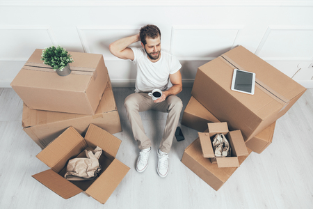 Top view. Man moving into his new homeの写真素材