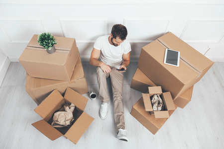 Top view. Man moving into his new homeの写真素材