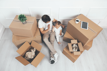 Top view. Father and son moving into their new homeの写真素材