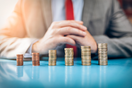 Businessman and his financial investment on the tableの写真素材