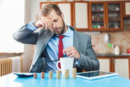 Working from home. Young businessman checking on returns from his investmentの写真素材
