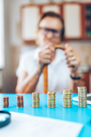Senior woman at home checking her finances and investmentsの写真素材