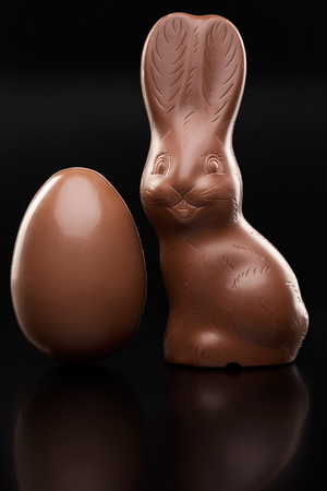 Delicious chocolate Easter bunny, eggs and sweets on rustic backgroundの写真素材