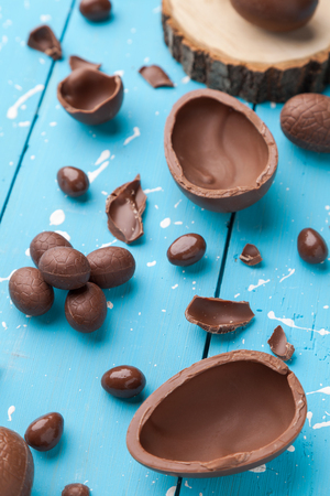 Delicious chocolate Easter bunny, eggs and sweets on rustic backgroundの写真素材