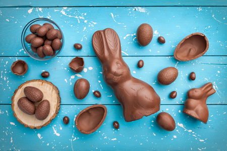 Delicious chocolate Easter bunny, eggs and sweets on rustic backgroundの写真素材