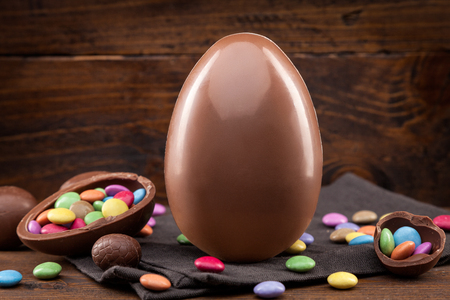 Delicious chocolate Easter holiday egg on rustic backgroundの写真素材