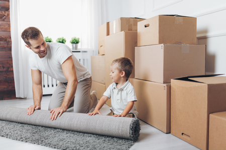 Moving concept, Father and his son moving into their new homeの写真素材