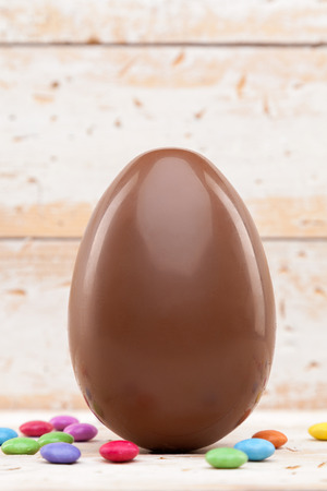 Delicious chocolate Easter holiday egg on rustic backgroundの写真素材