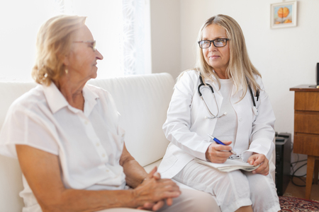 Senior woman during a medical exam with her practitionerの写真素材