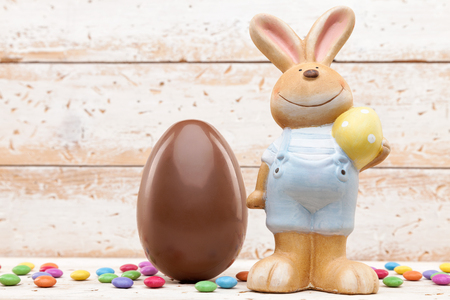Delicious chocolate Easter holiday egg on rustic backgroundの写真素材