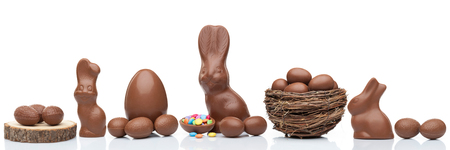 Delicious chocolate Easter bunny, eggs and sweets on white backgroundの写真素材