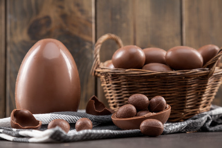 Delicious chocolate Easter bunny, eggs and sweets on rustic backgroundの写真素材