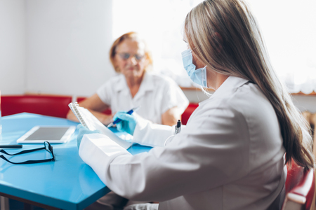 Senior woman during a medical exam with her practitionerの写真素材
