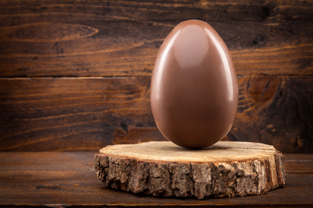 Delicious chocolate Easter holiday egg on rustic backgroundの写真素材