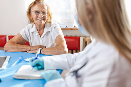 Senior woman during a medical exam with her practitionerの写真素材