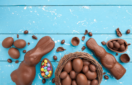 Delicious chocolate Easter bunny, eggs and sweets on rustic backgroundの写真素材