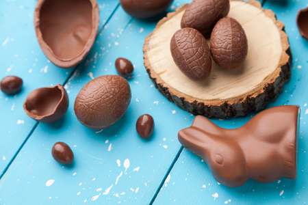 Delicious chocolate Easter bunny, eggs and sweets on rustic backgroundの写真素材