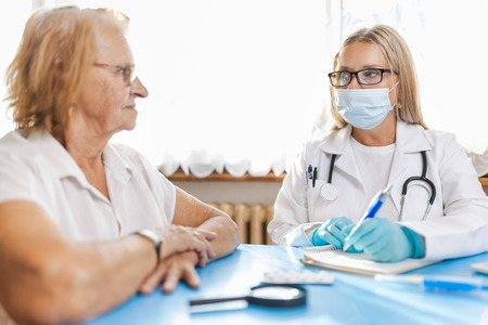 Senior woman during a medical exam with her practitionerの写真素材