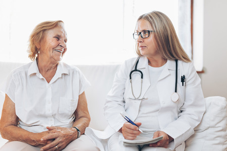 Senior woman during a medical exam with her practitionerの写真素材
