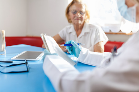 Senior woman during a medical exam with her practitionerの写真素材