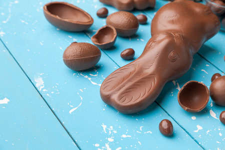 Delicious chocolate Easter bunny, eggs and sweets on rustic backgroundの写真素材