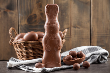 Delicious chocolate Easter bunny, eggs and sweets on rustic backgroundの写真素材