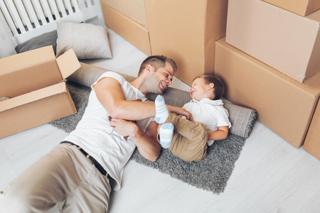 Moving concept, Father and his son moving into their new homeの写真素材