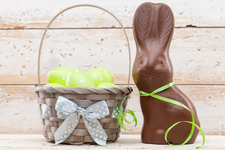 Delicious chocolate Easter bunny, eggs and sweets on rustic backgroundの写真素材