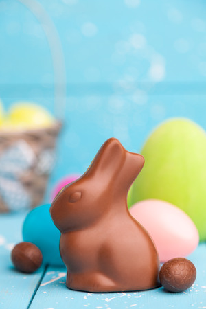 Delicious chocolate Easter bunny, eggs and sweets on rustic backgroundの写真素材