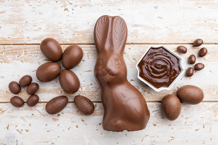 Delicious chocolate Easter bunny, eggs and sweets on rustic backgroundの写真素材