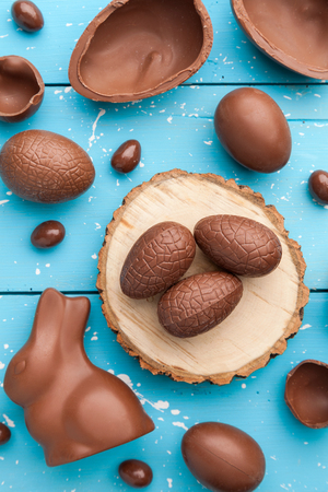 Delicious chocolate Easter bunny, eggs and sweets on rustic backgroundの写真素材