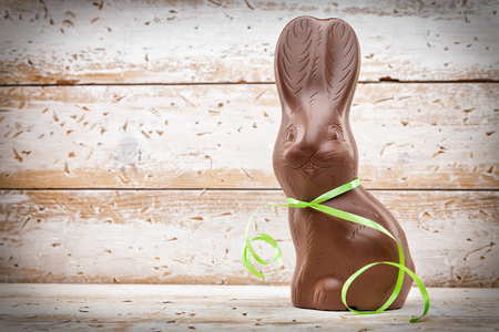 Delicious chocolate Easter bunny, eggs and sweets on rustic backgroundの写真素材