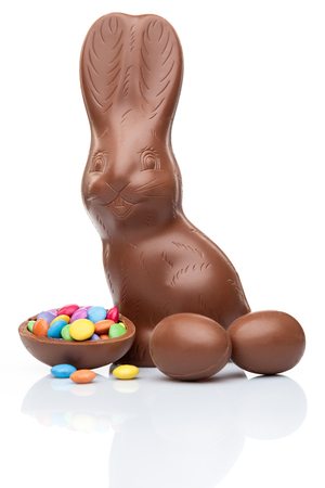 Delicious chocolate Easter bunny, eggs and sweets on white backgroundの写真素材